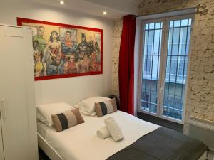 1 dormitorio con cama y ventana grande en 15 Atelier Montorgueil Super Héros, en París