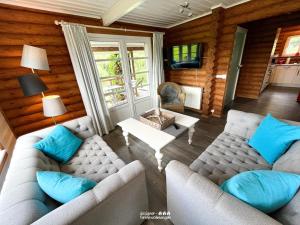 a living room with two couches and a table at villa kunterBUNT in Grödersby