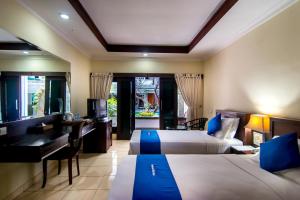 Postel nebo postele na pokoji v ubytování Champlung Mas Hotel Legian