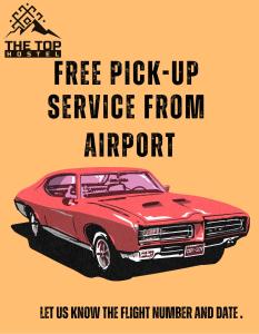 a red muscle car with the words free pick up service from airport at The Top Hostel in Tashkent