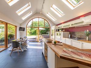 a kitchen with skylight ceilings and a dining area at 4 Bed in Braunton 75574 in Braunton
