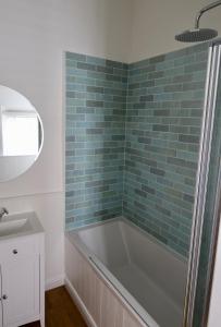 y baño con bañera y lavamanos. en Drift Cottage - Fisherman's Cottage Brixham harbour, en Brixham