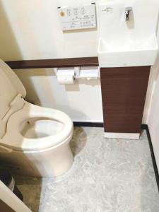 a bathroom with a white toilet and a sink at Asakusa Inn 屋上バルコニー付き100m2広々快適一棟ハウス in Tokyo