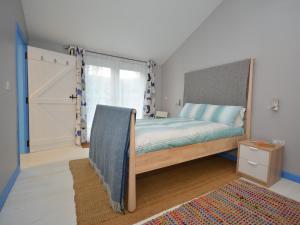 a bedroom with a bed and a sliding door at 2 bed in Llansteffan 74268 in Ferryside