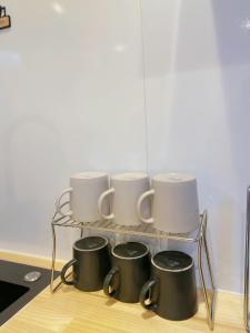 a rack of coffee mugs sitting on top of a counter at Asakusa Inn 屋上バルコニー付き100m2広々快適一棟ハウス in Tokyo