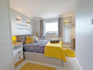 a small bedroom with a bed and a window at The Gables in Bognor Regis