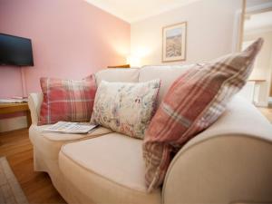2 Bed in Howden G0113 في Saltmarshe: غرفة معيشة مع أريكة بيضاء مع وسائد