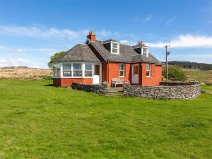 a red house with a stone wall in a field at 2 bed in Kilfinan CA183 in Kilfinan