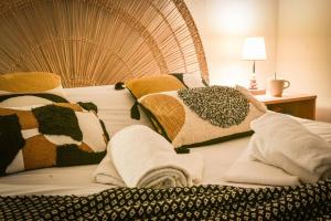 a bed with blankets and pillows on top of it at Lumineux - Elixir - Parking privé in Strasbourg
