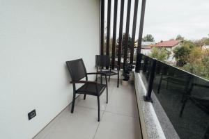 a balcony with two chairs on a balcony at Grgic Apartments - Lux APT2 in Zagreb