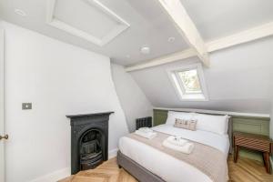 a bedroom with a bed and a fireplace at Aldwark Attic is 4 min to The Shambles with Free Wifi in York