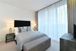 a bedroom with a bed and a large window at PARK LANE LARGE LUXURY SLEEPS 6 in London