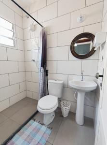 a bathroom with a toilet and a sink at Casa Monjardim in Vitória