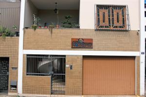 a building with two garage doors and a sign on it at Casa Monjardim in Vitória