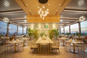 a rendering of a restaurant with tables and chairs at La Terrazza Hotel in Famagusta
