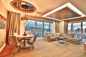 a living room with a couch and a table at Bof Hotels Ceo Suites Atasehir in Istanbul