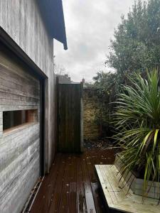 a wooden walkway next to a building with a fence at Luxury Guest House in Woodstock