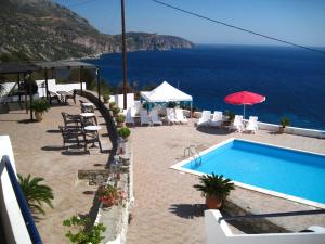 a swimming pool with a view of the ocean at Studios Avra in Akhladherí