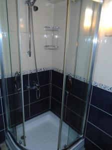 a shower in a bathroom with black and white tiles at City House in Istanbul