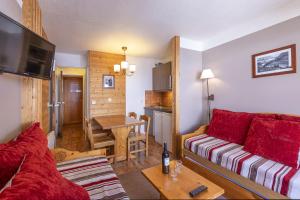 a living room with a couch and a table at Résidence Le Pralin in Les Allues