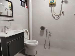 a bathroom with a toilet and a sink and a shower at SS Ipoh Comfort Homestay - Taman Bertuah in Ipoh +26 photos