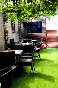 a group of tables and chairs on the grass at Coded Hub Guest House in Lekki