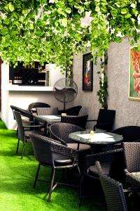 a restaurant with tables and chairs on green grass at Coded Hub Guest House in Lekki