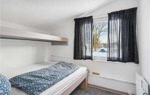 a bedroom with a bed and a window at Beautiful Apartment In Ringkbing With Wifi in Ringkøbing