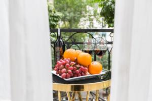 a plate of fruit and wine glasses on a table at Blubiz Hotel 5 in Hanoi