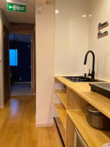 a kitchen with a sink and a counter top at Asakusa Inn 屋上バルコニー付き100m2広々快適一棟ハウス in Tokyo