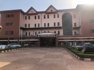 a parking lot in front of a hotel at Roban Hotels Limited in Enugu
