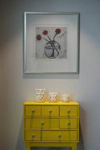 a yellow dresser with a picture on the wall at Stay Vibe Healing House in Seoul