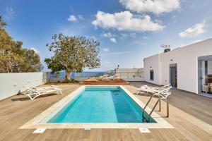 a swimming pool on the roof of a house at Villa Emilia - with private swimming pool in Agia Pelagia