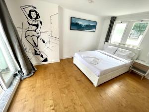 a bedroom with a bed and a drawing on the wall at Double Bedroom near Beach with Private terrace 3rd floor No Lift Room 9 in Oeiras