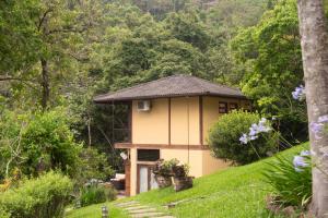 a small house on a hill in a forest at Pousada Terra Crua in Visconde De Maua