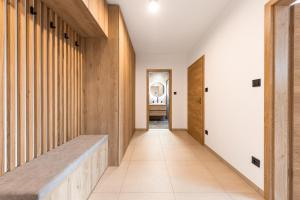 un pasillo con paneles de madera y un banco en Horem Dolem Apartmán en Cerny Dul