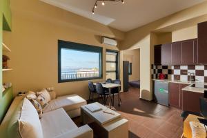 a living room with a couch and a kitchen at City Center Modern Penthouse in Heraklio Town