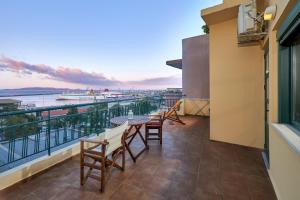 a balcony with tables and chairs and a view of the water at City Center Modern Penthouse in Heraklio Town