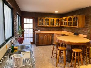 uma cozinha com um lavatório e uma mesa de madeira em Linda Casa en Barrio Residencial la Herradura Oriente a 5 min playa em Coquimbo