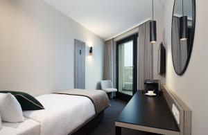 Ein Bett oder Betten in einem Zimmer der Unterkunft Leonardo Hotel Vienna City West