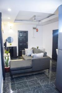 a living room with a couch in a room at The Grenadines Apartment in Lagos