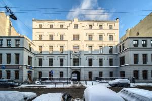 a large white building with snow in front of it at Loft Studio with Mezzanine in Wrocław