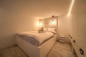 een slaapkamer met een bed met twee verlichting bij Loft Studio with Mezzanine in Wrocław
