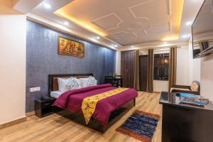 um quarto com uma cama com um cobertor roxo em Viable Inn by Vista Stays em Mukteshwar