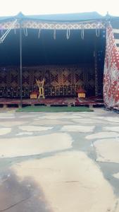 a stage with a tent and a table and chairs at مخيم يمك دروبي in AlUla