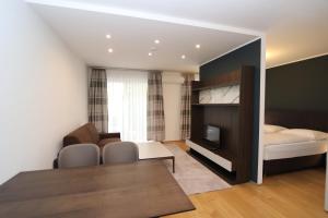 a living room with a bed and a dining room at Vienna Stay Apartments Tabor 1020 in Vienna