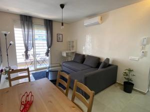 a living room with a couch and a table at 30° apartment paradise of the sun in Agadir