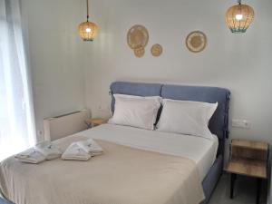 a bedroom with a bed with two towels on it at Nostos Luxury Villas with Private Pool in Nafpaktos in Nafpaktos