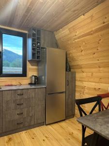 a kitchen with a stainless steel refrigerator and a table at Borjomi Story in Borjomi