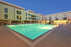 a large swimming pool in the middle of a building at Hotel Terme Marine Leopoldo II TERME & SPA in Marina di Grosseto